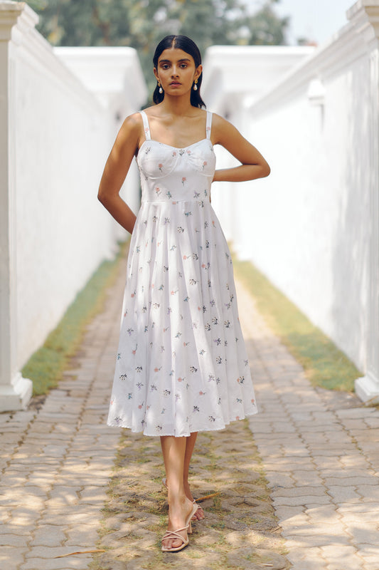 Spin or twirl in this effortless summer dress featuring delicate floral prints